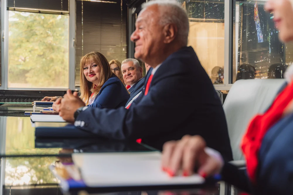 Mature businesspeople having meeting at boardroom table in modern office.